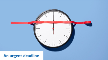 A clock with red tape across the face and text that reads “An urgent deadline.”